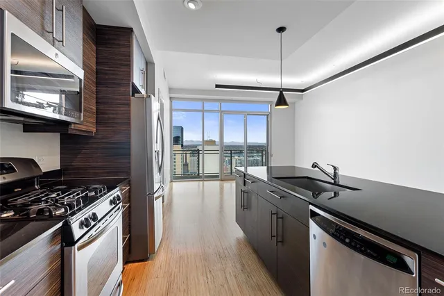 a kitchen with a sink a stove and cabinets