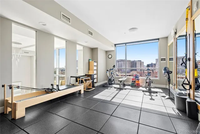 a room with gym equipment and view of living room