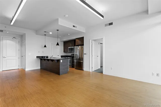 a large kitchen with cabinets and stainless steel appliances