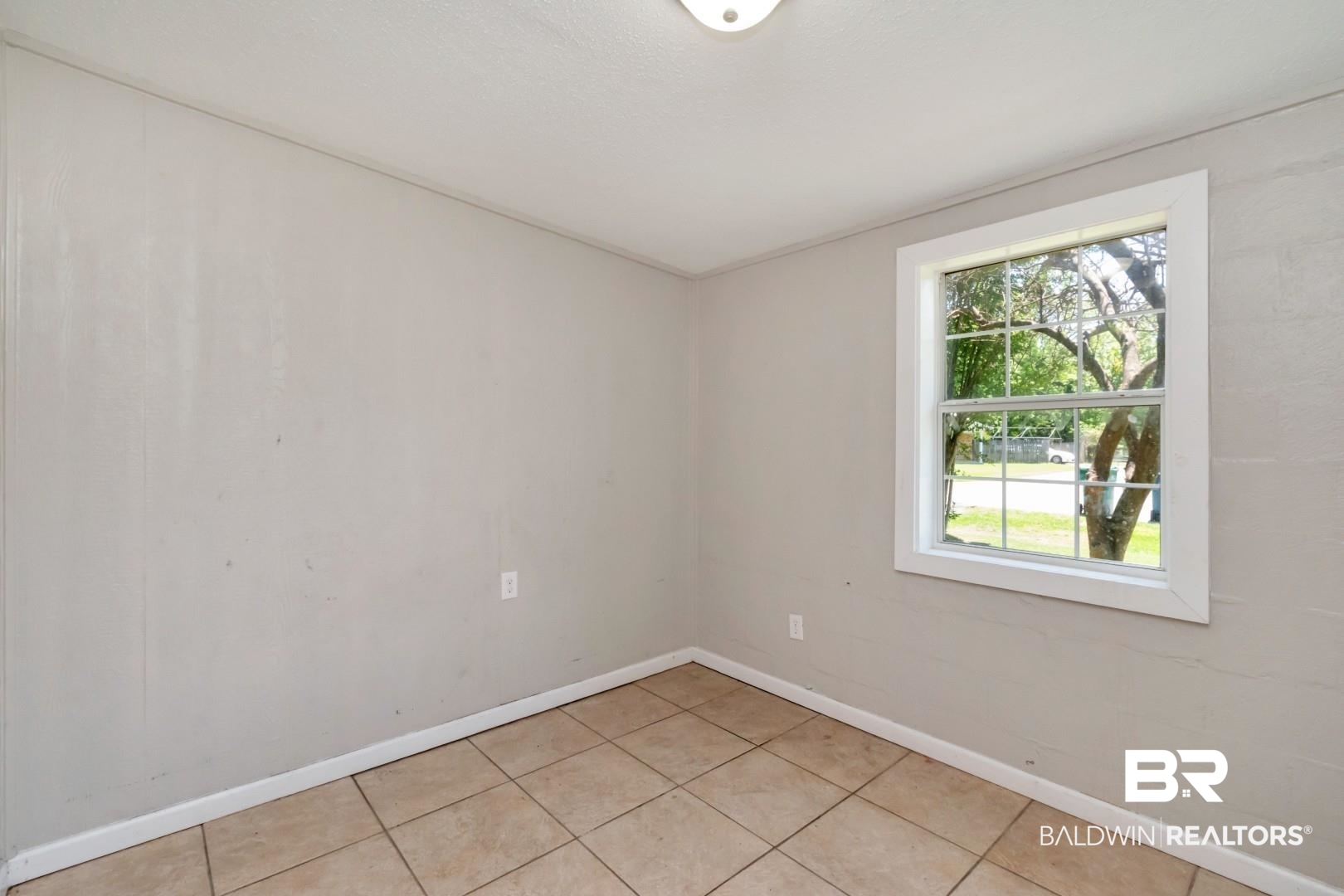 5650 Alice Drive Theodore, AL 36582 - Photo 10 of 15 Empty room featuring light tile patterned flooring and baseboards