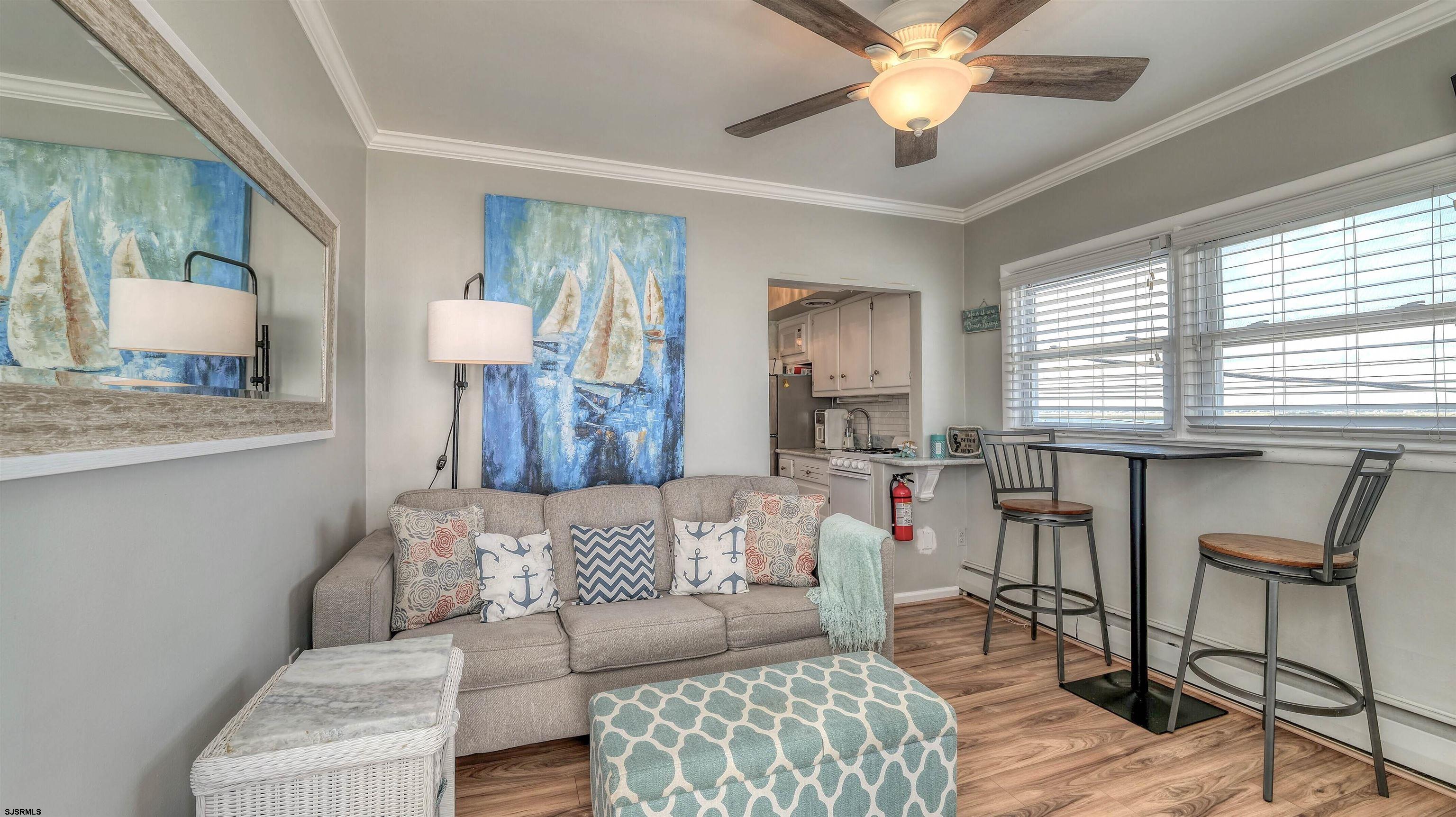 9500 Amherst Avenue, Unit 10 AKA 9 Margate City, NJ 08402 - Photo 3 of 20 a living room with furniture and a chandelier