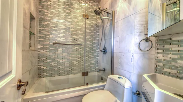 a bathroom with a bathtub toilet and shower