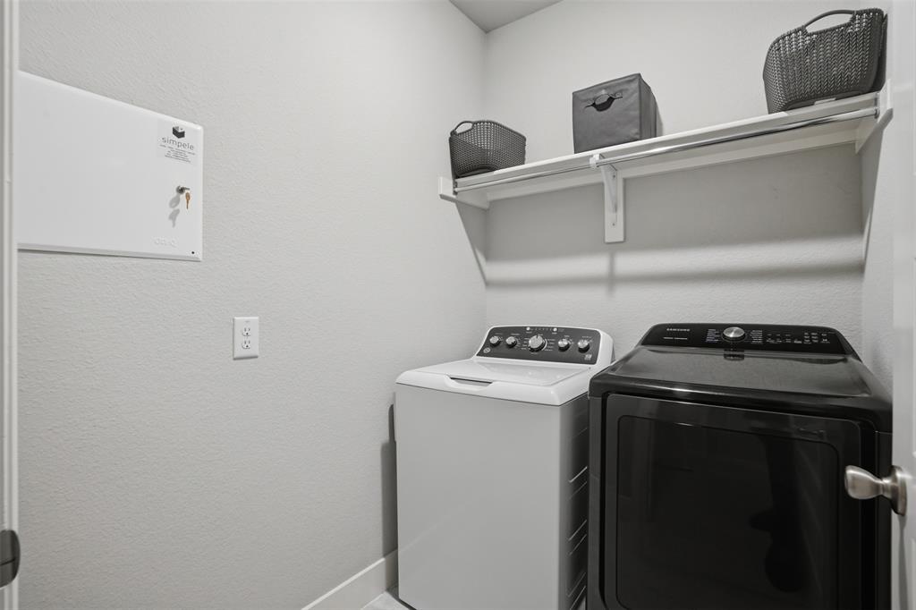 1429 Eclipse Road Aubrey, TX 76227 - Photo 22 of 37 Dedicated laundry area featuring a white top-load washing machine and a black front-load dryer