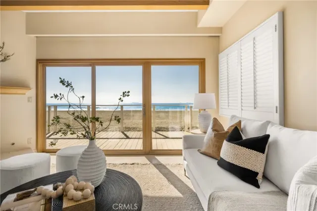 a living room with furniture and a floor to ceiling window