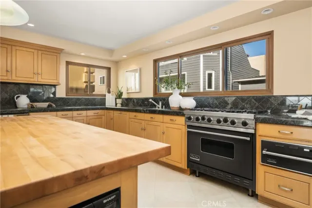 a kitchen with stainless steel appliances a stove sink and cabinets