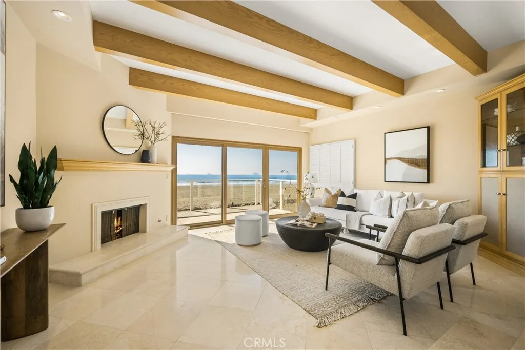 78 Surfside Avenue Surfside, CA 90743 - Photo 2 of 45 a living room with furniture a fireplace and a potted plant