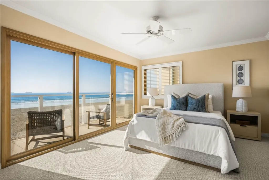78 Surfside Avenue Surfside, CA 90743 - Photo 25 of 45 a spacious bedroom with a large bed and a balcony view