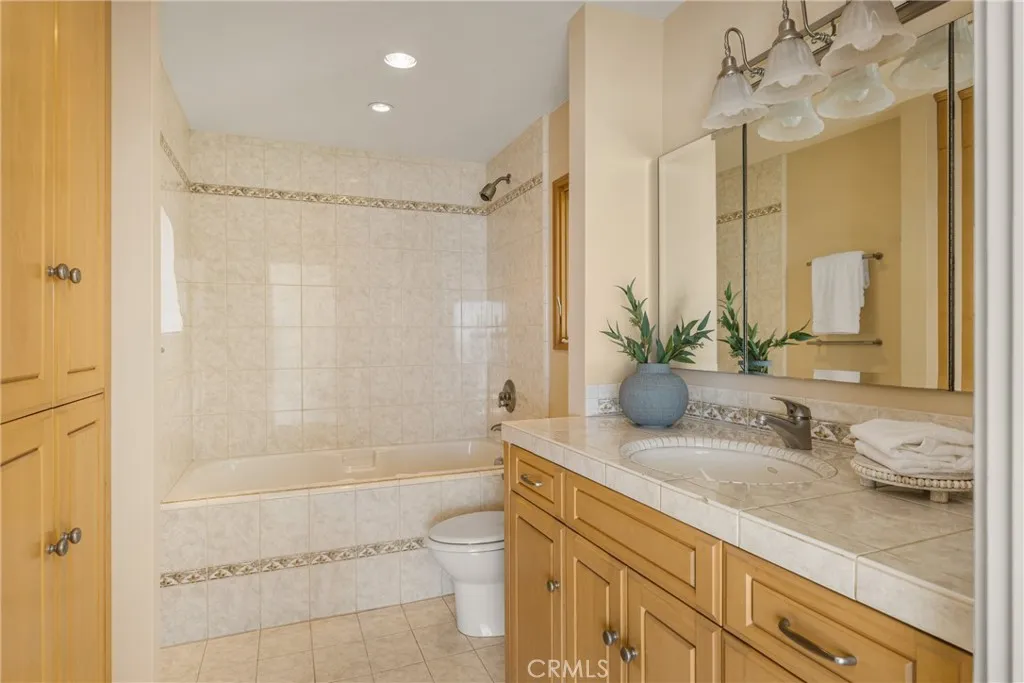78 Surfside Avenue Surfside, CA 90743 - Photo 27 of 45 a bathroom with a granite countertop sink a toilet and shower