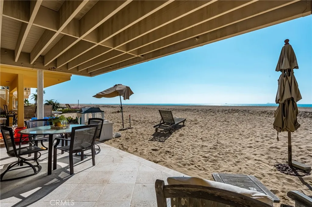 78 Surfside Avenue Surfside, CA 90743 - Photo 41 of 45 a view of a patio with a table and chairs under an umbrella