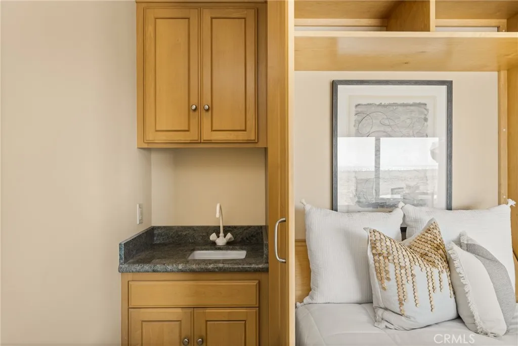 78 Surfside Avenue Surfside, CA 90743 - Photo 9 of 45 a bathroom with a granite countertop sink and a window
