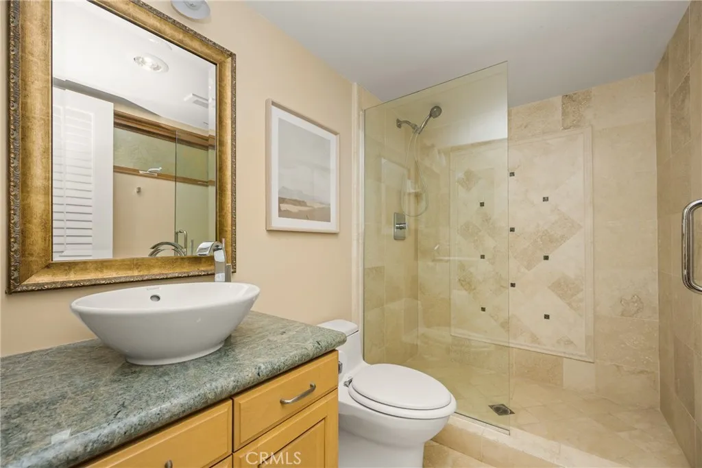78 Surfside Avenue Surfside, CA 90743 - Photo 10 of 45 a bathroom with a granite countertop sink toilet tub and shower