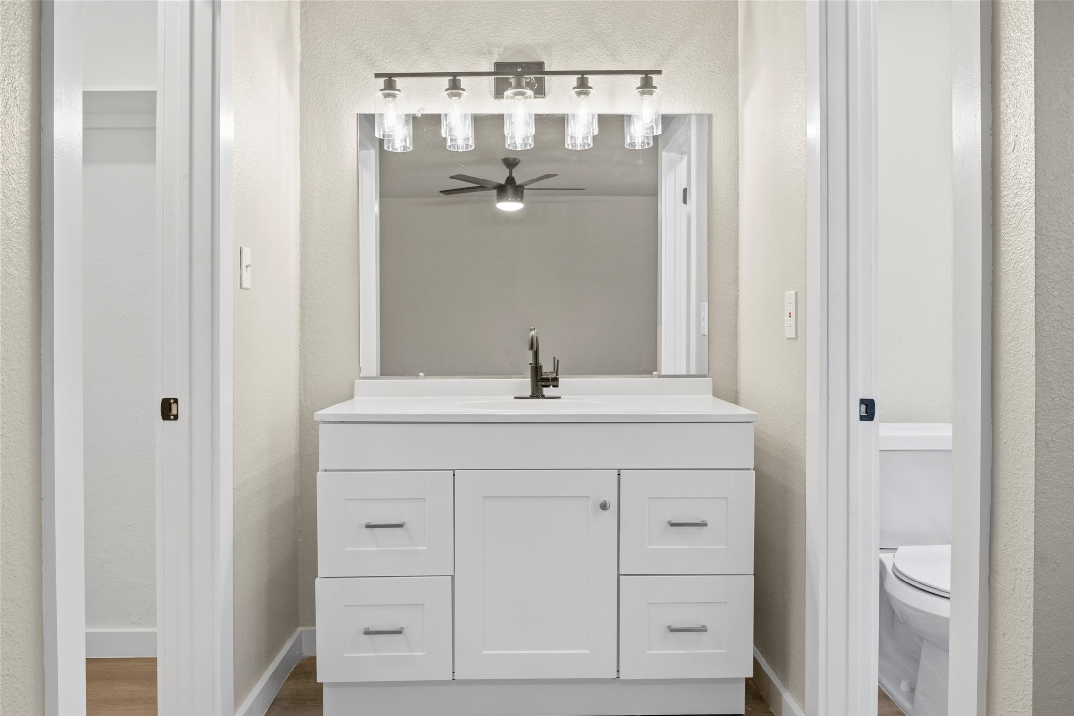 502 Pin Tail Lane Taylor, TX 76574 - Photo 17 of 26 White vanity with five drawers and a cabinet, topped with a white countertop and rectangular sink