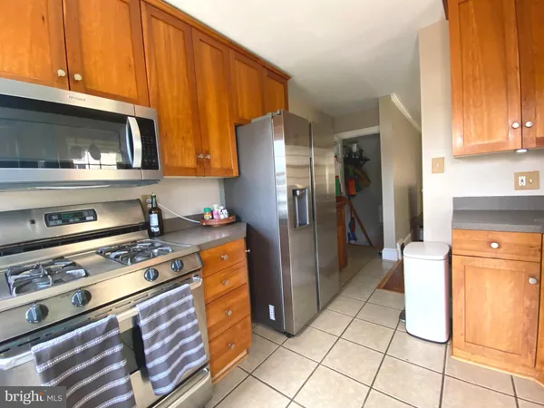 a kitchen with stainless steel appliances granite countertop a refrigerator stove and cabinets