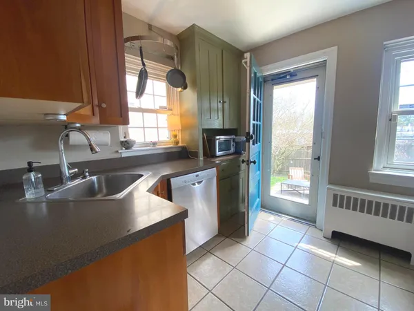 a kitchen with granite countertop a sink and a stove top oven