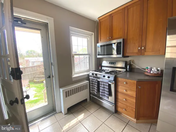 a kitchen with stainless steel appliances a stove a sink and a microwave