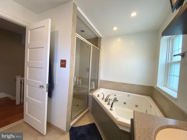 a bathroom with a bathtub and a shower