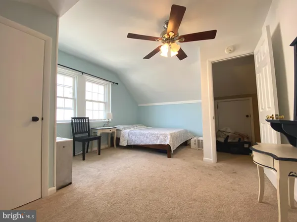 a bedroom with furniture and a window