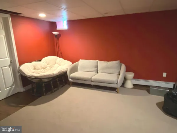 a living room with furniture and a lamp