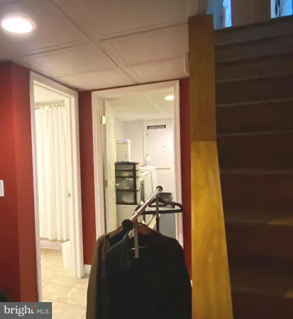 a hallway with a large window and a wooden floor