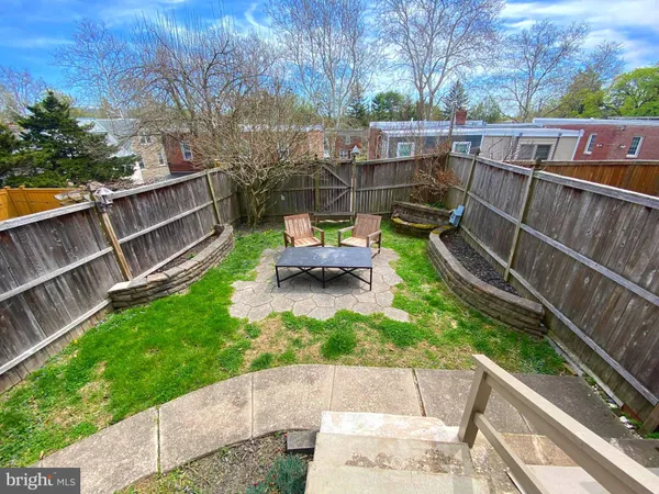 a view of a backyard with sitting area