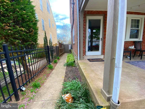 a view of a pathway both side of the house