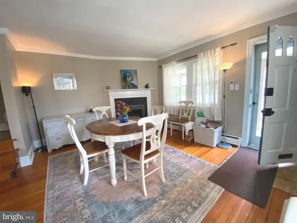 a view of a dining room with furniture and a potted plant