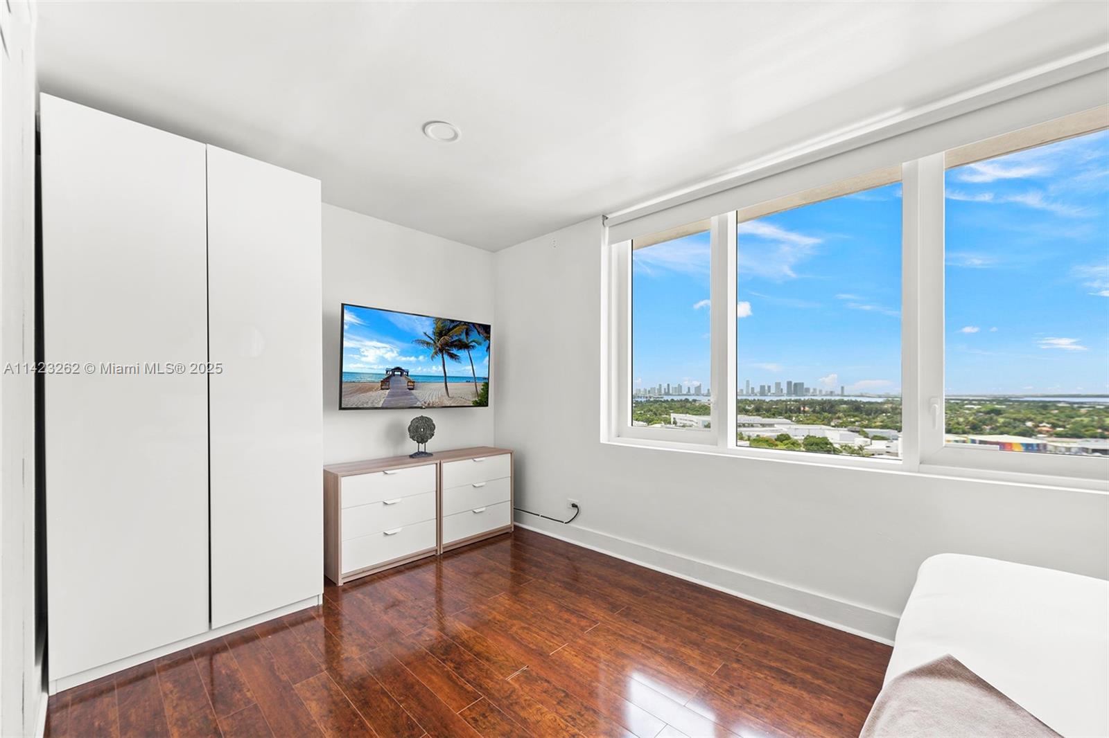 Mid Beach Miami Beach, FL 33139 - Photo 11 of 30 a living room with furniture and a flat screen tv