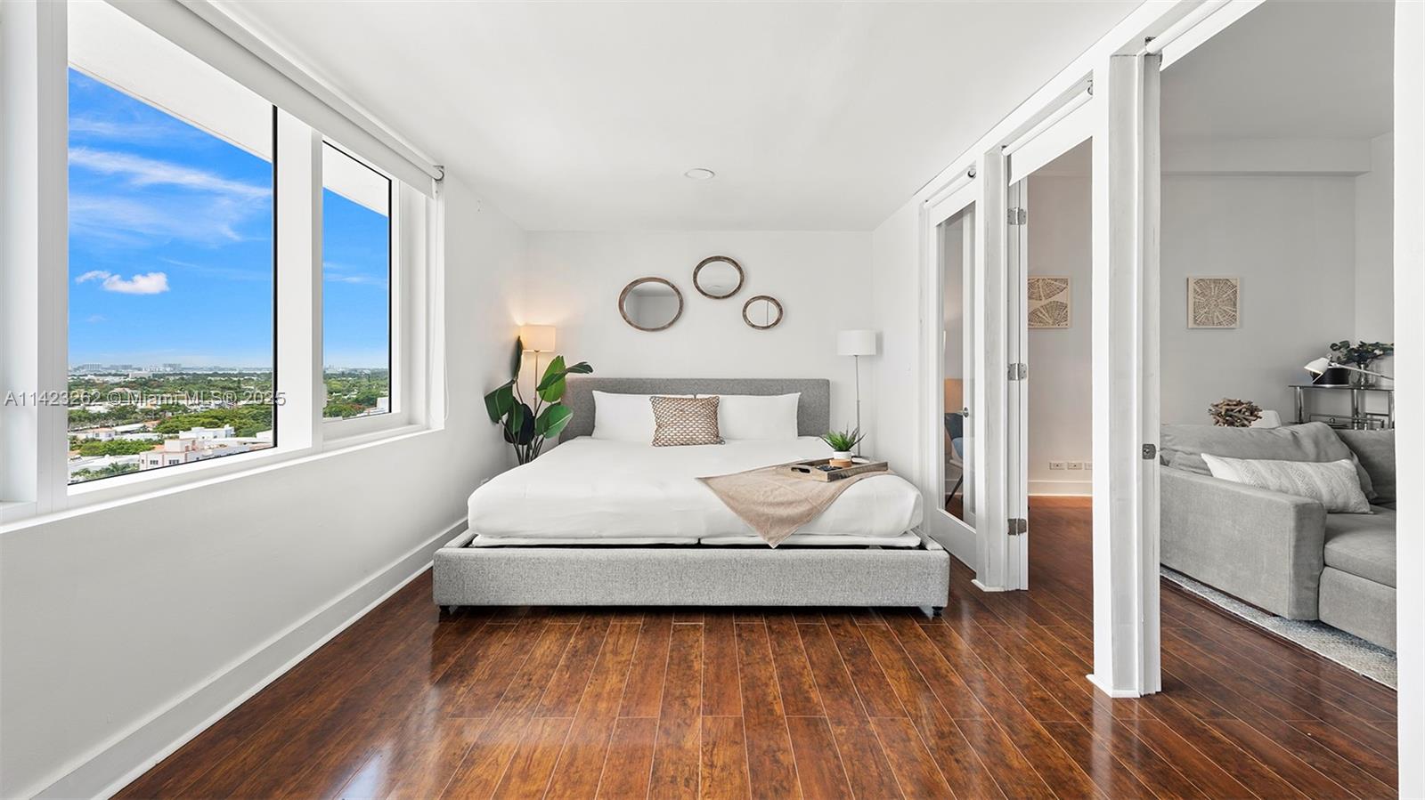 Mid Beach Miami Beach, FL 33139 - Photo 12 of 30 a bedroom with a large bed and a large window