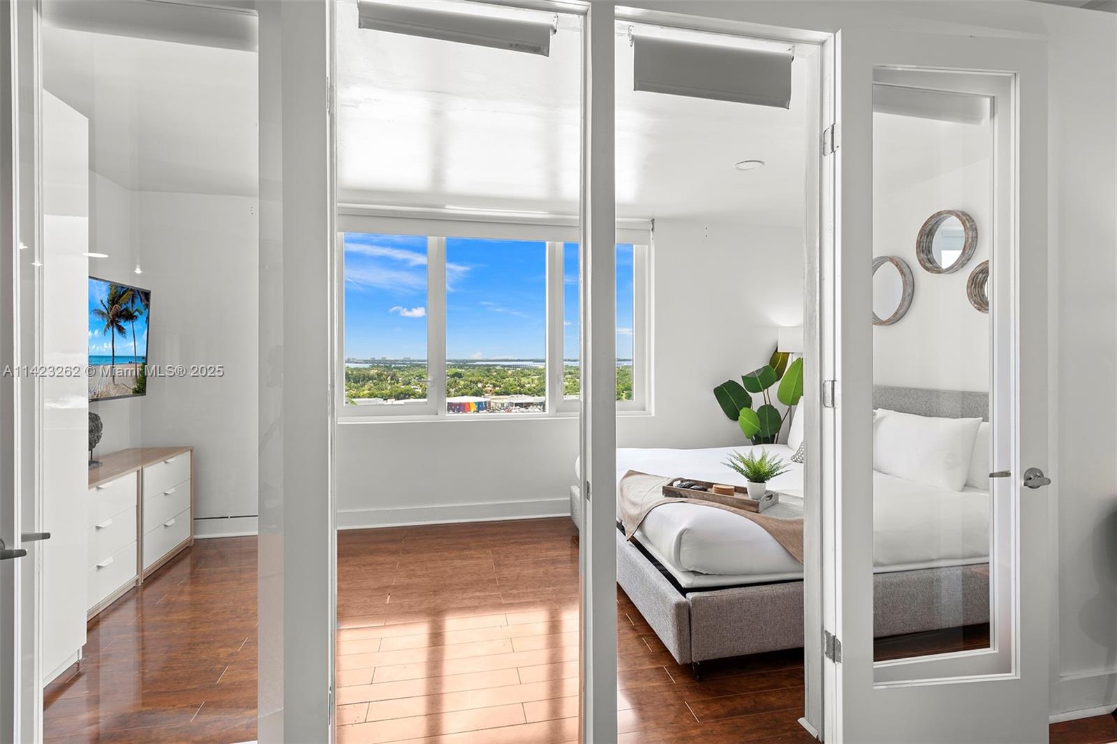 Mid Beach Miami Beach, FL 33139 - Photo 13 of 30 a bedroom with a bed and a window