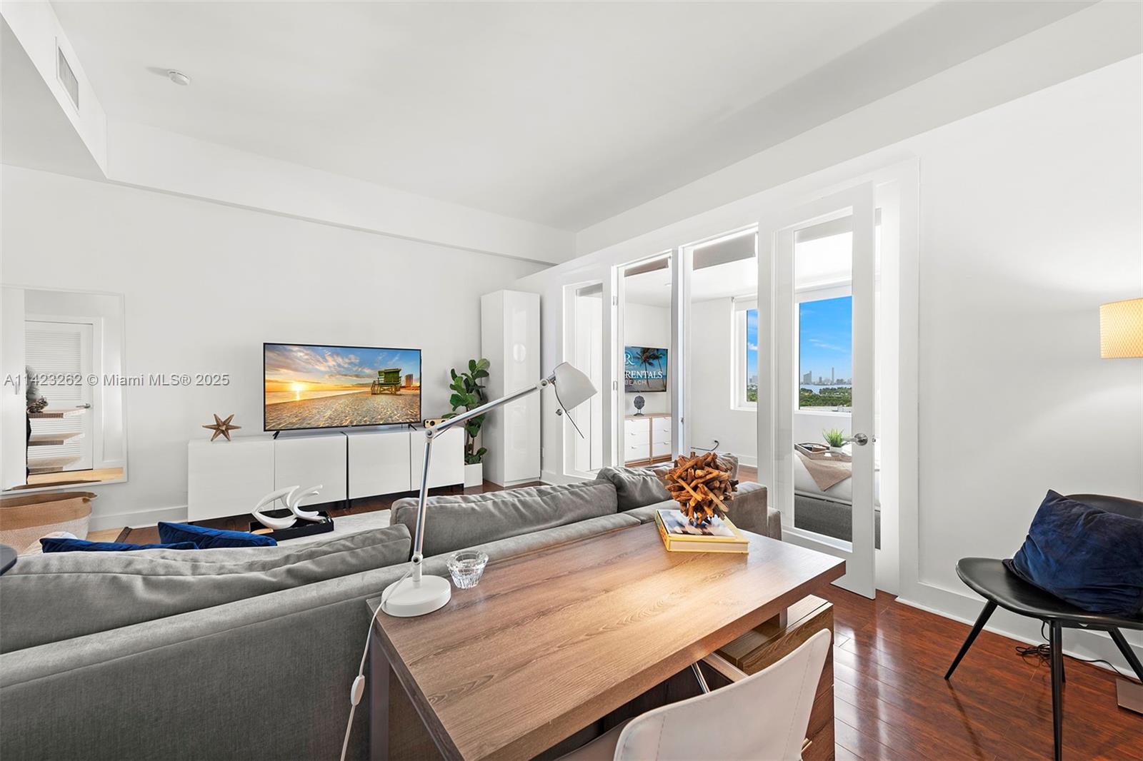 Mid Beach Miami Beach, FL 33139 - Photo 15 of 30 a living room with furniture and a flat screen tv