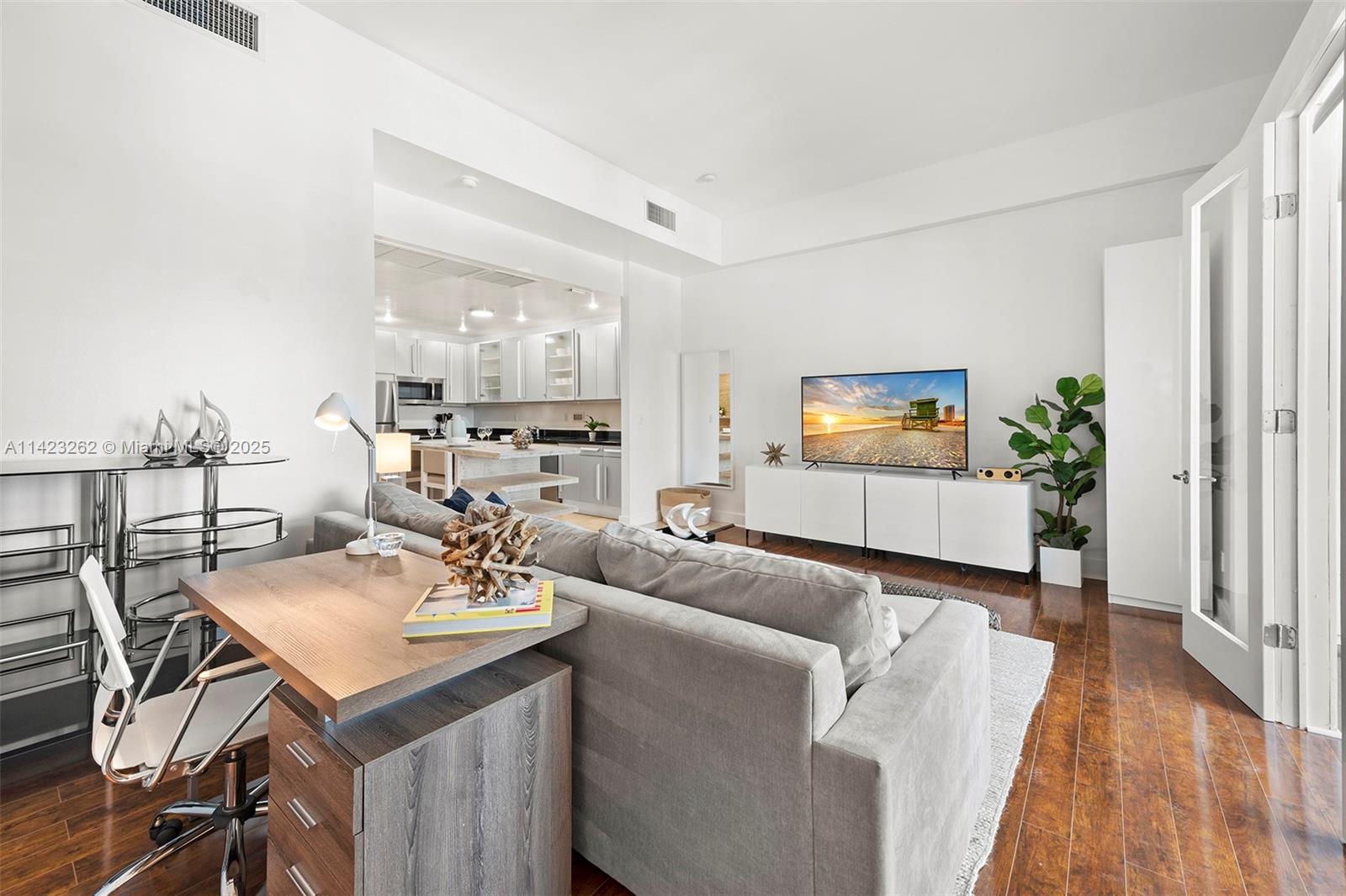 Mid Beach Miami Beach, FL 33139 - Photo 16 of 30 a living room with furniture and a wooden floor