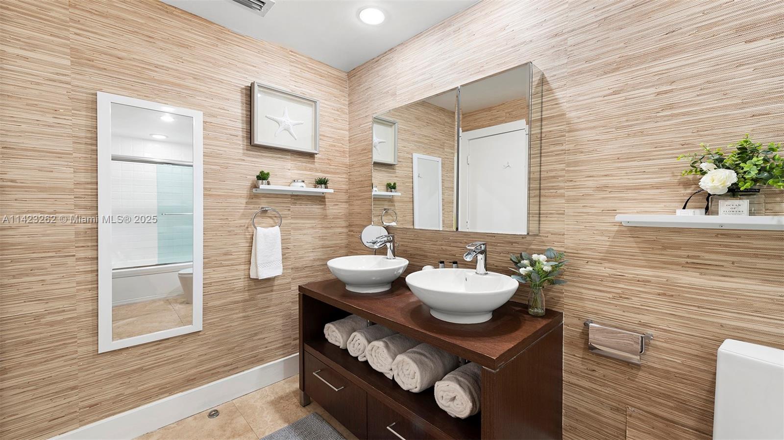 Mid Beach Miami Beach, FL 33139 - Photo 28 of 30 a bathroom with a sink vanity granite and a mirror