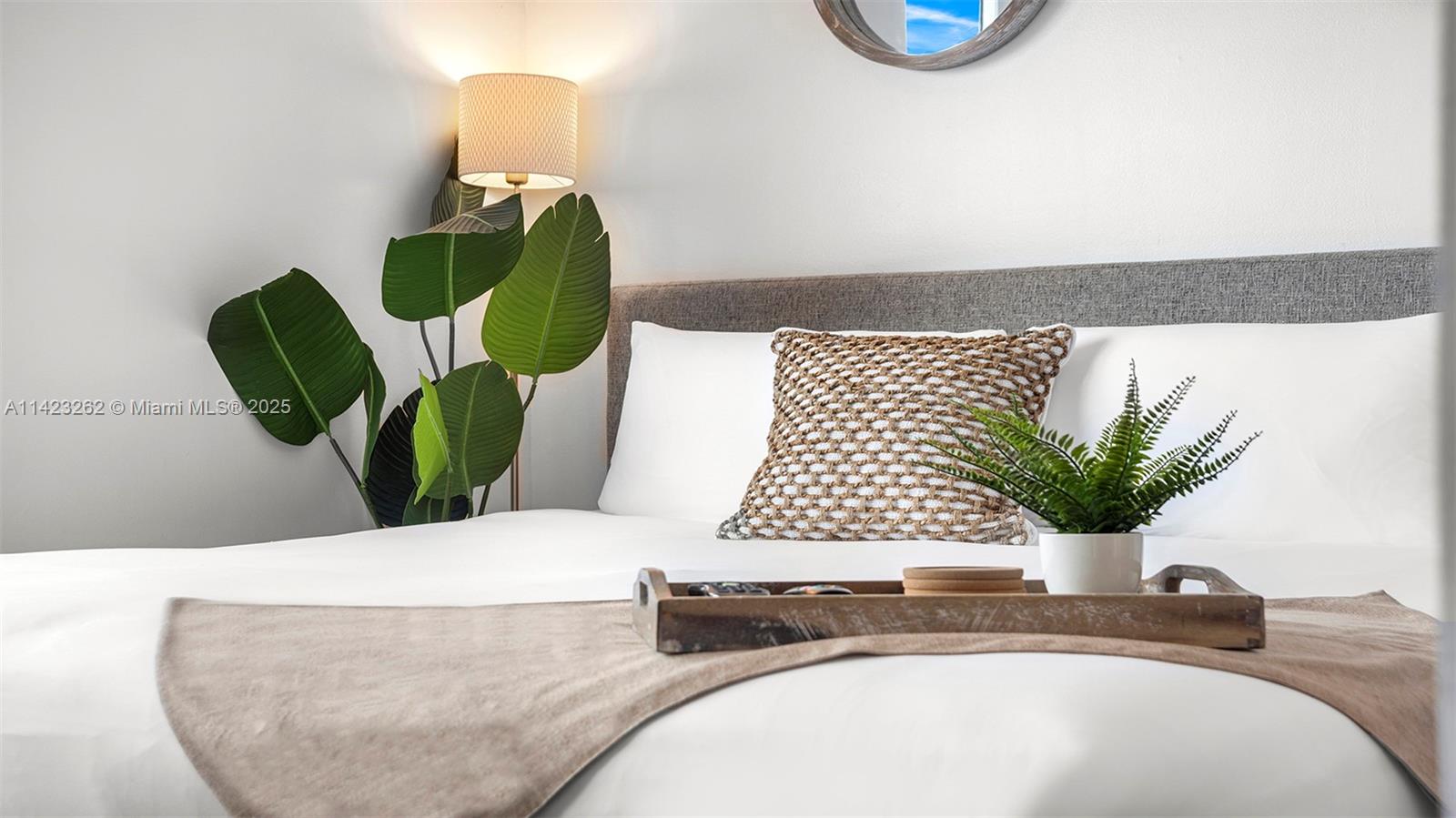 Mid Beach Miami Beach, FL 33139 - Photo 9 of 30 a bathroom with a sink a mirror and a potted plant