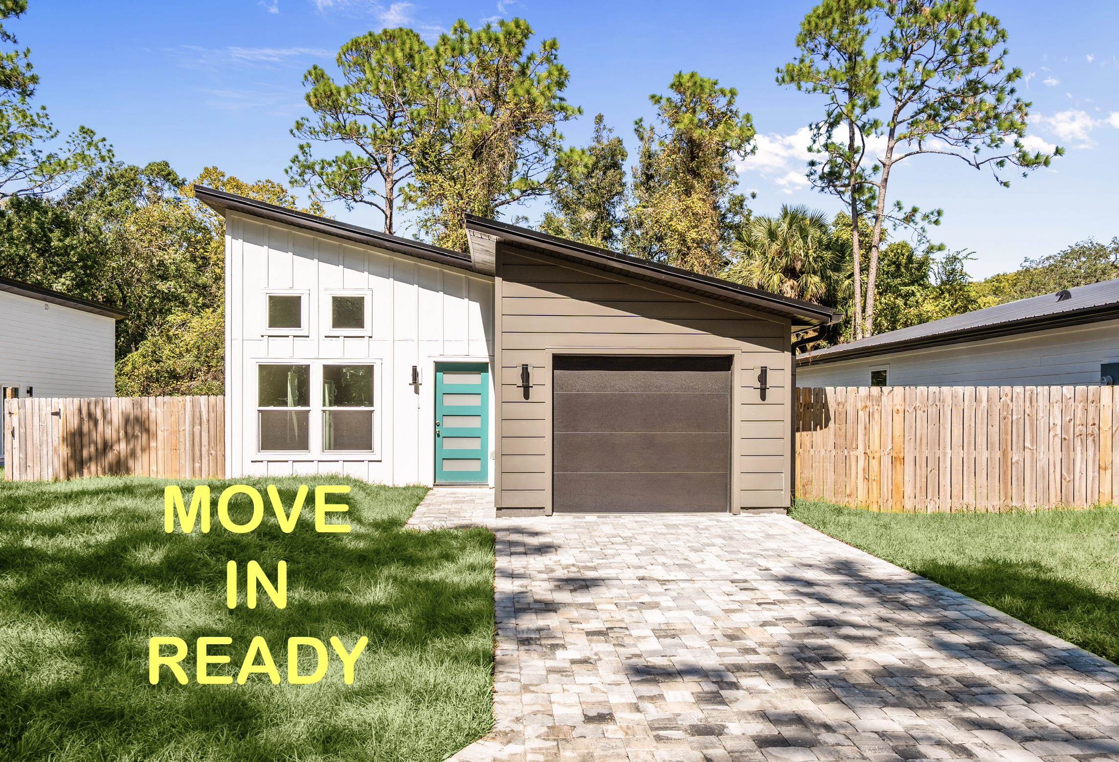 View of front of house featuring driveway, an attached garage, and board and batten siding