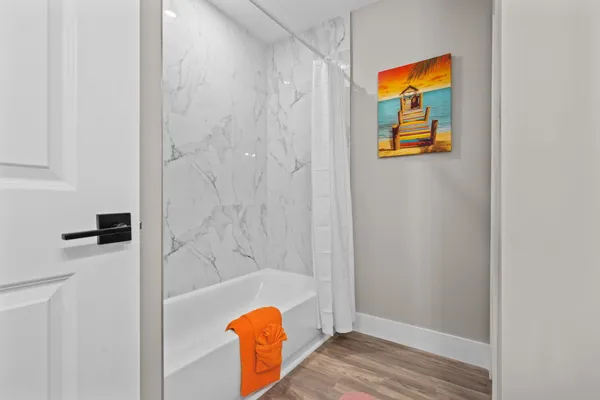 a view of backyard with potted plants and large tree