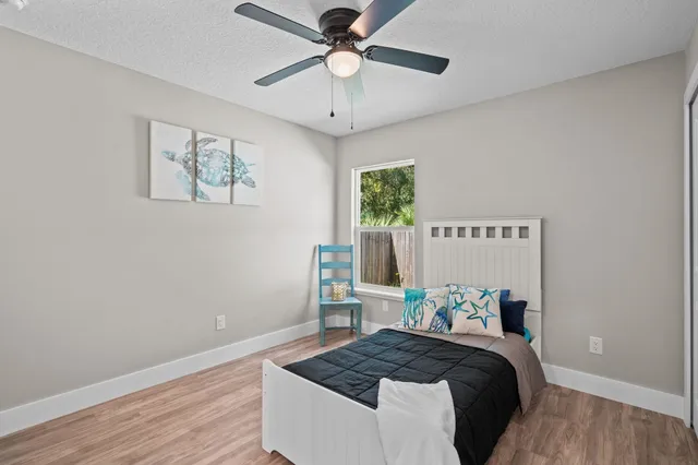 a bed room with a bed and a chandelier