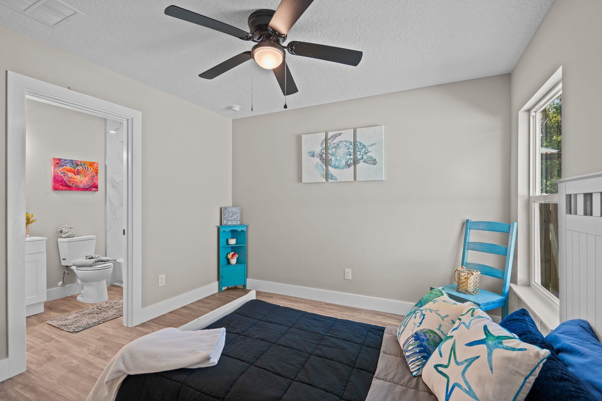804 West 9th Street St. Augustine, FL 32084 - Photo 22 of 31 Living area with wood finished floors, a textured ceiling, and a ceiling fan