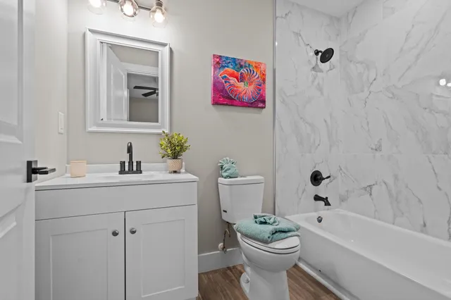 a bathroom with a sink a toilet and shower