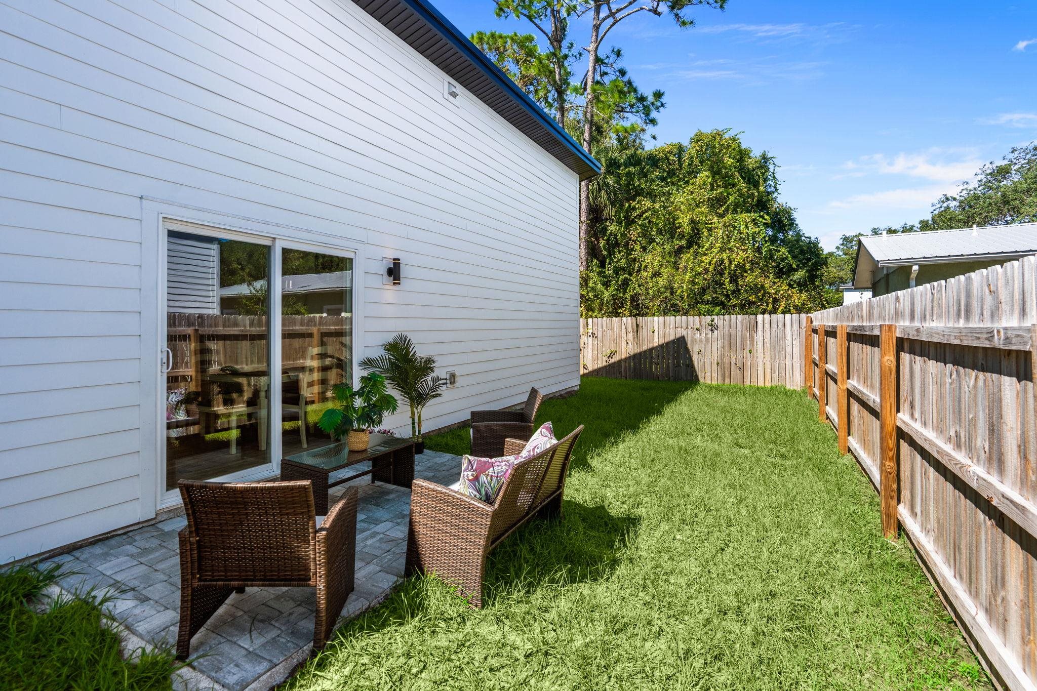 804 West 9th Street St. Augustine, FL 32084 - Photo 25 of 31 Fenced backyard featuring a patio and an outdoor hangout area