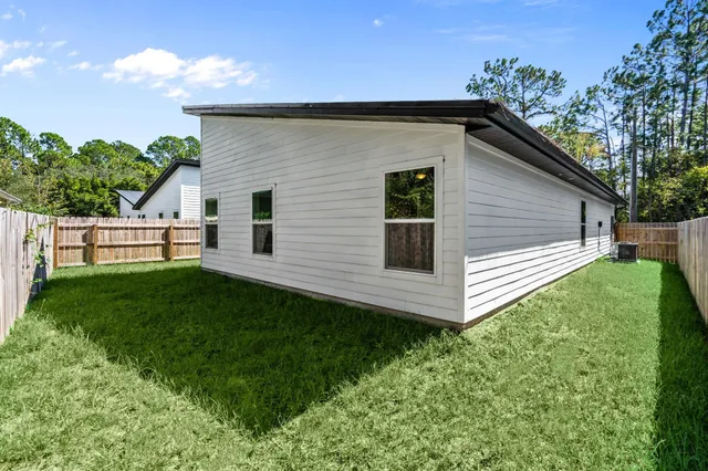 a view of a backyard with plants and a patio
