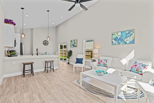 a living room with furniture and a wooden floor