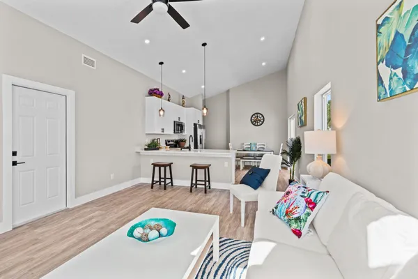 a kitchen with kitchen island a dining table and chairs