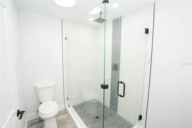 a bathroom with a glass shower door