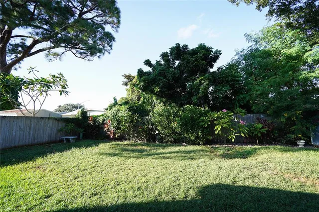 a view of a backyard with wooden fence