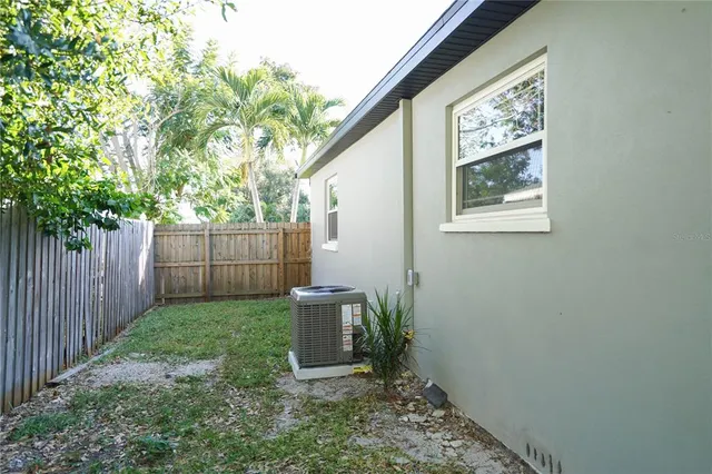 a backyard of a house with a garden and plants