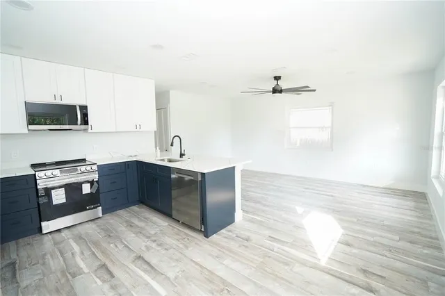a kitchen with stainless steel appliances granite countertop a sink and stove top oven