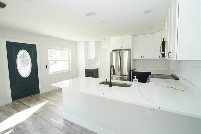 a kitchen with a refrigerator a sink a stove and a refrigerator