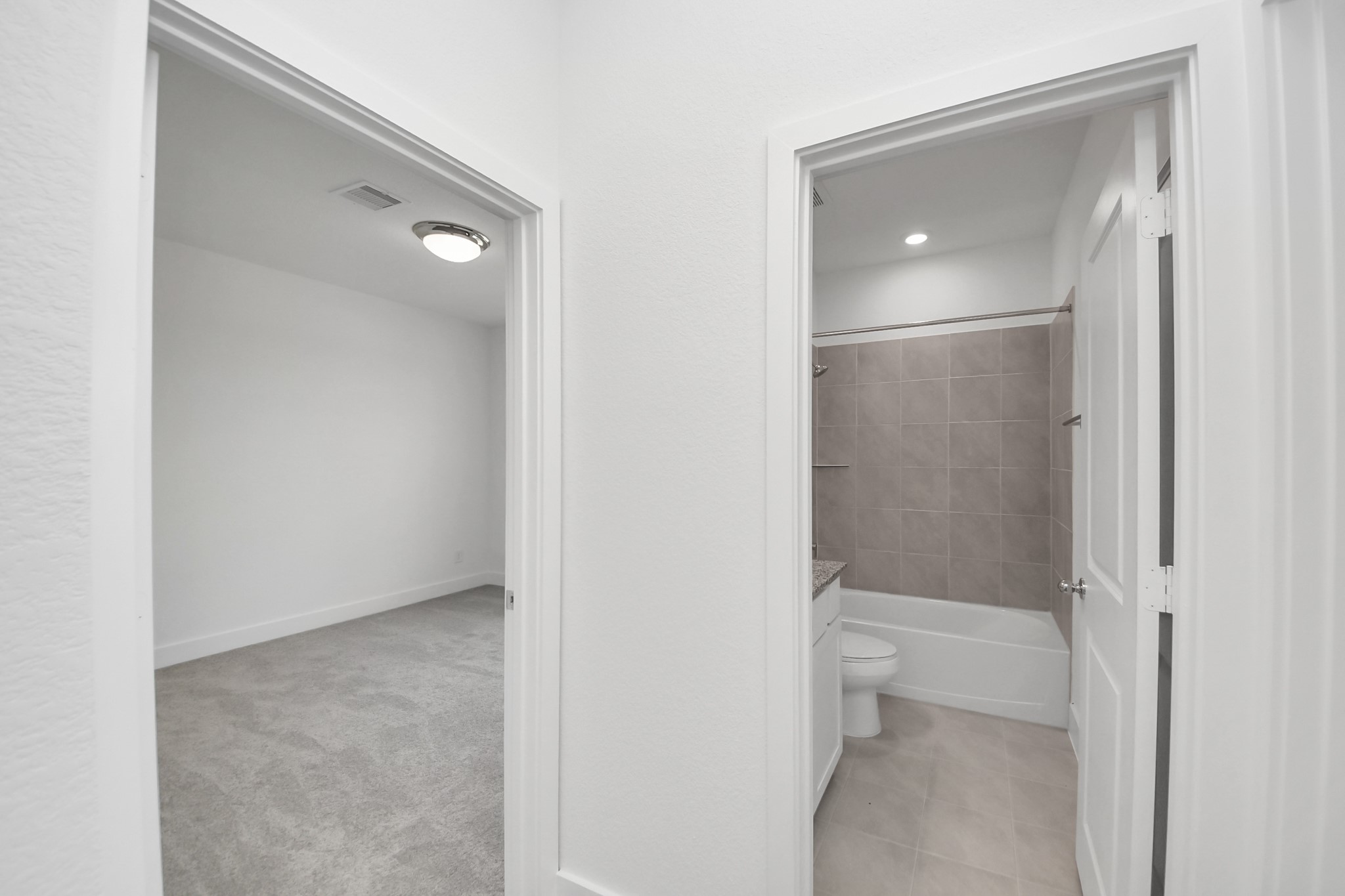 14439 Trumpet Lane Splendora, TX 77372 - Photo 19 of 37 a bathroom with a shower and a toilet