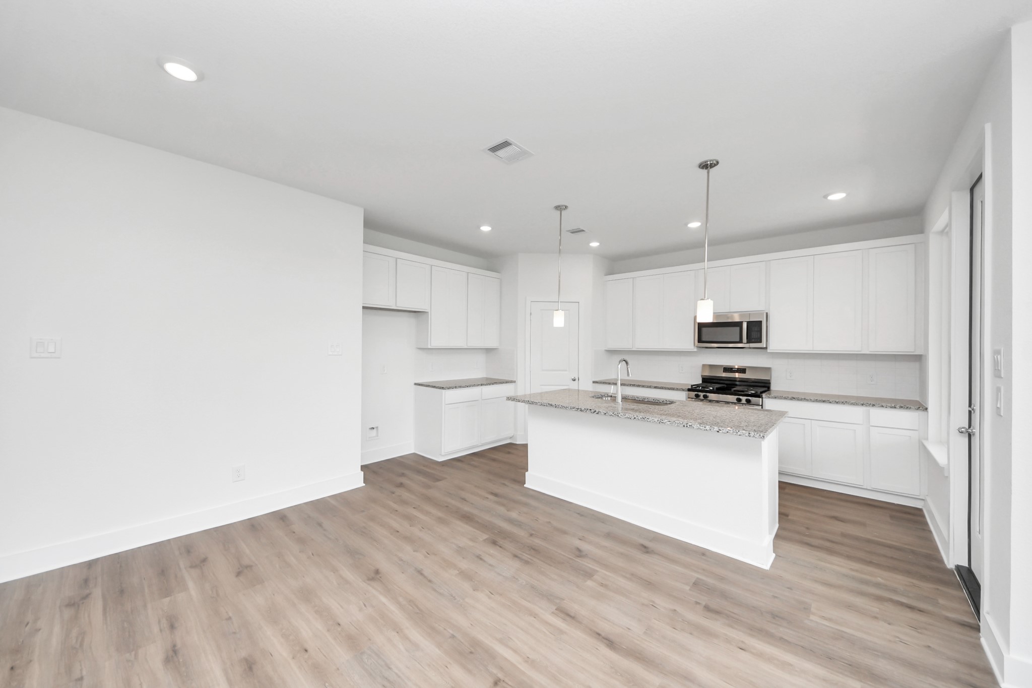 14439 Trumpet Lane Splendora, TX 77372 - Photo 6 of 37 a kitchen with a sink cabinets and wooden floor