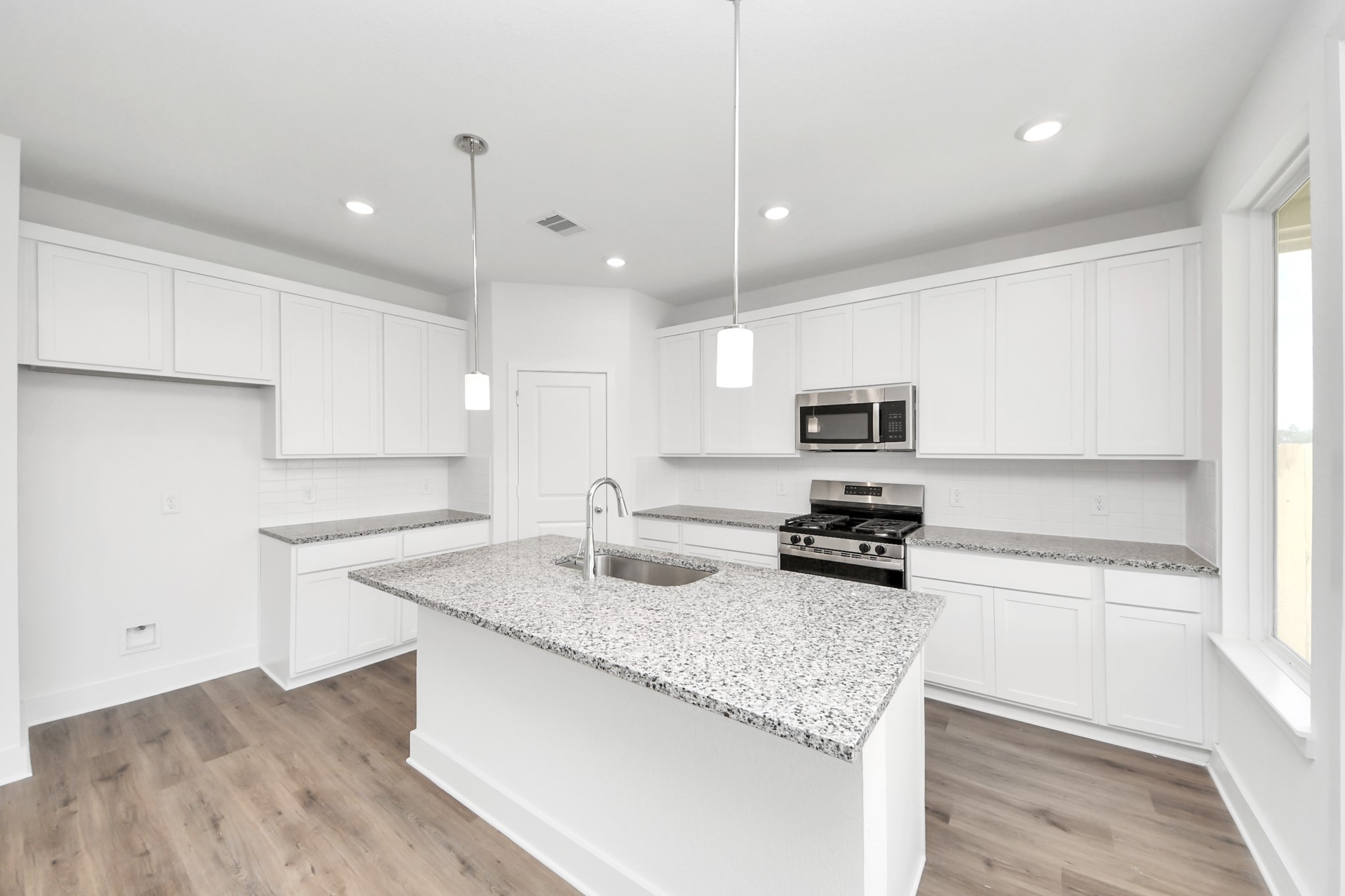 14439 Trumpet Lane Splendora, TX 77372 - Photo 7 of 37 a kitchen with granite countertop stainless steel appliances and wooden cabinets